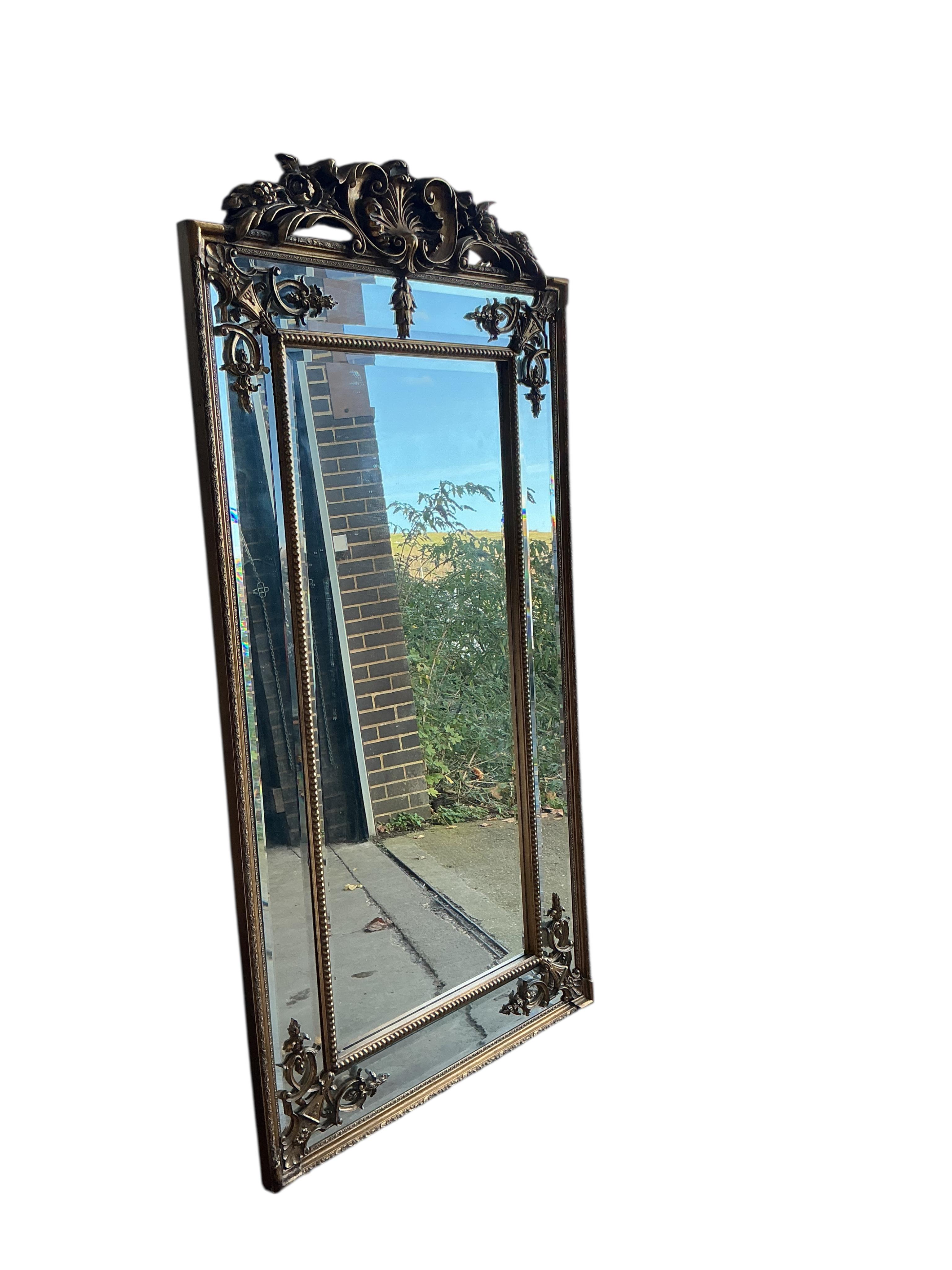 A reproduction Victorian style gilt composition overmantel mirror, width 91cm, height 184cm